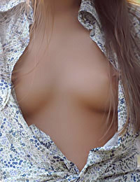 This blonde cutie models outdoors and strips down to her shirt.
